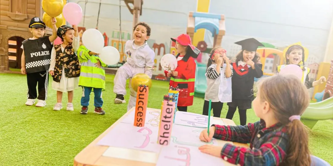 Children dressed as a police officer, firefighter, astronaut and graduate on World Children's Day