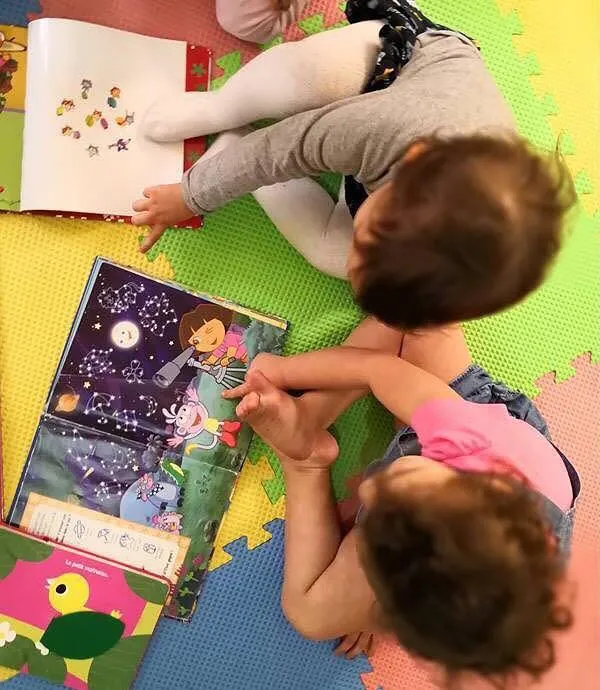 Toddlers looking at picture books together